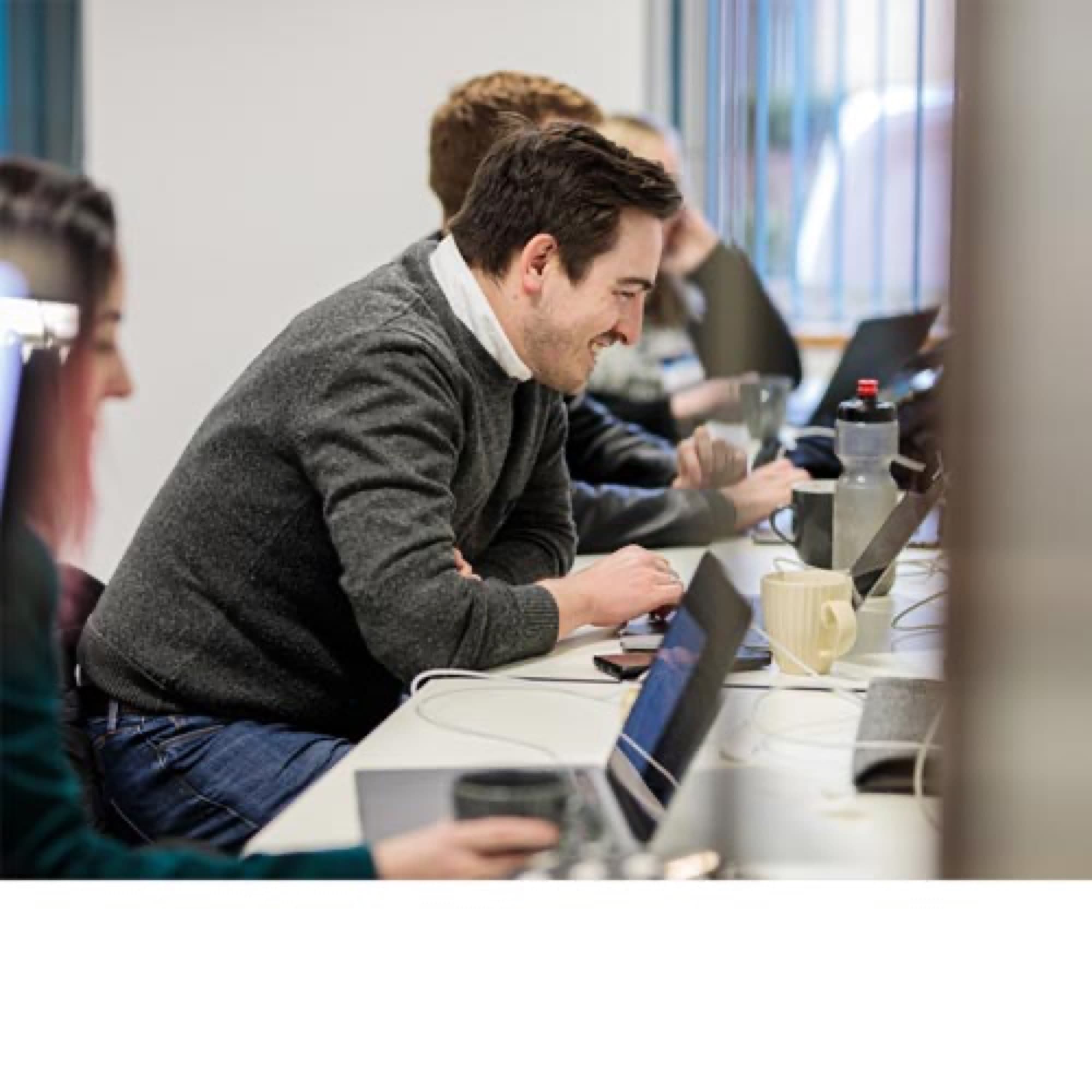 An energy analyst reviewing data at a laptop.